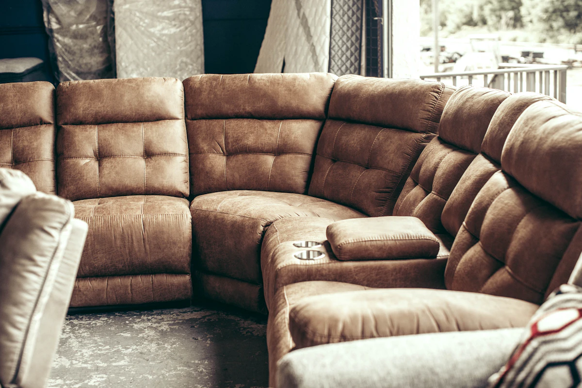Brown tufted reclining sectional with built-in cup holders