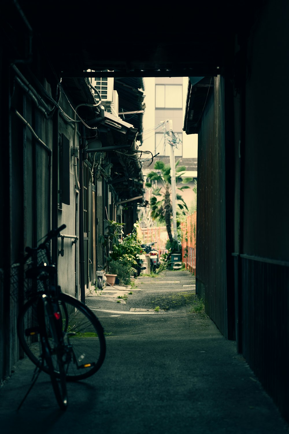 a bicycle parked in a alley
