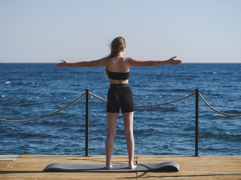 a person doing yoga on a dock