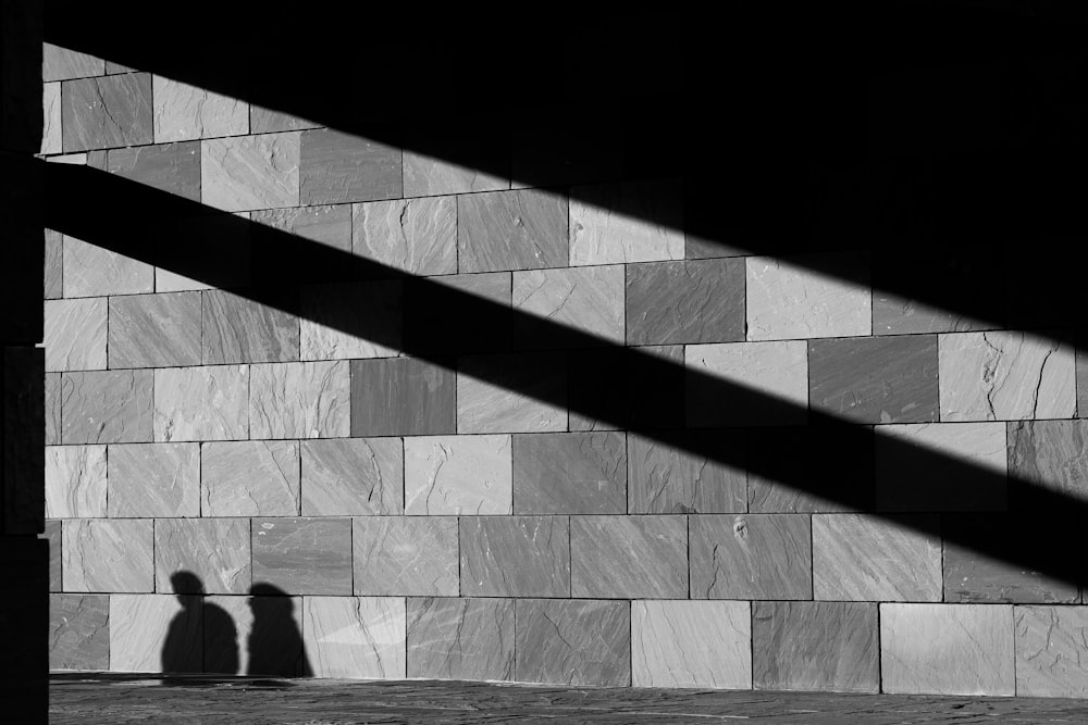 a shadow of a person on a tile floor