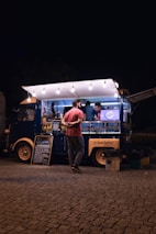 a person standing next to a food truck