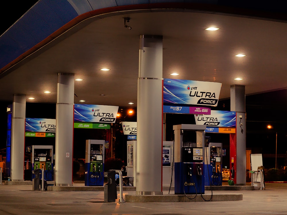 a gas station with signs