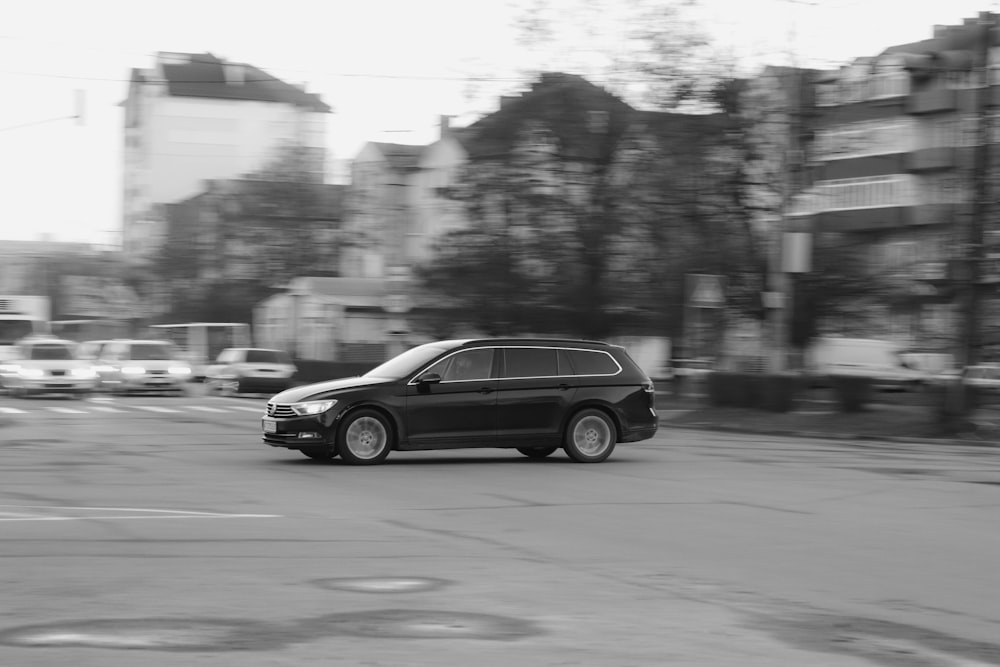 a black car driving on a road