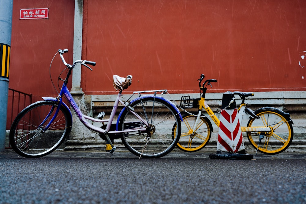 bicycles parked by a wall