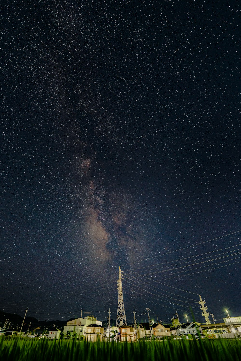 a city with a tower in the distance at night