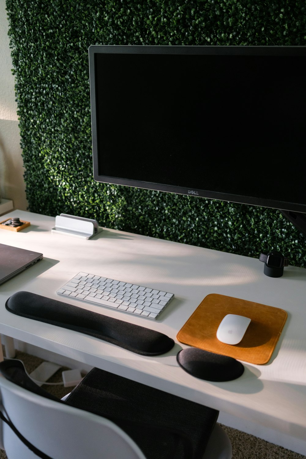 a computer monitor and keyboard on a desk