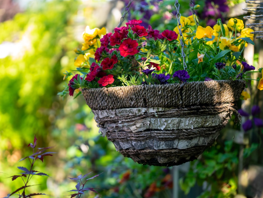 a bird bath with flowers in the background