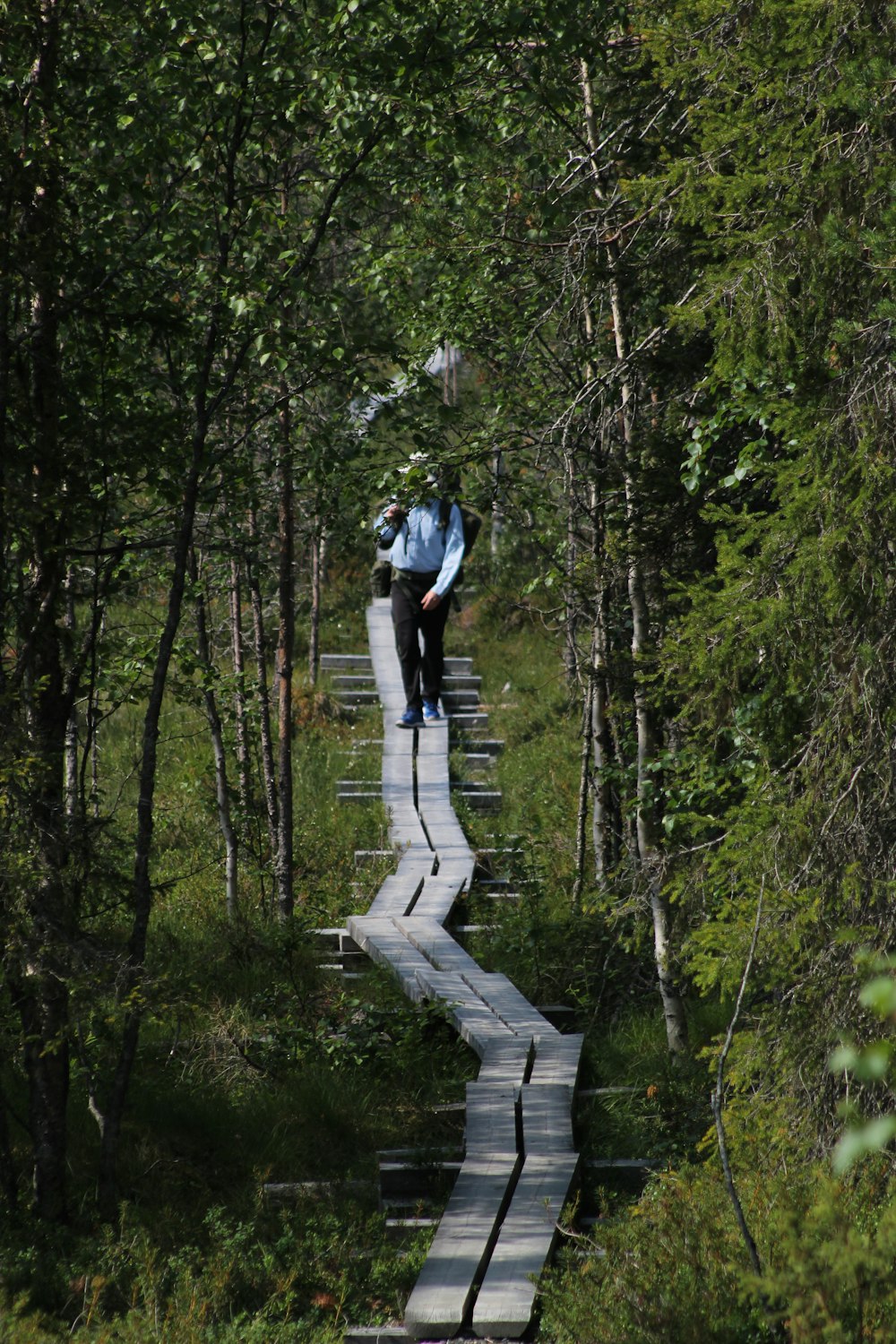a man walking on a stone bridge