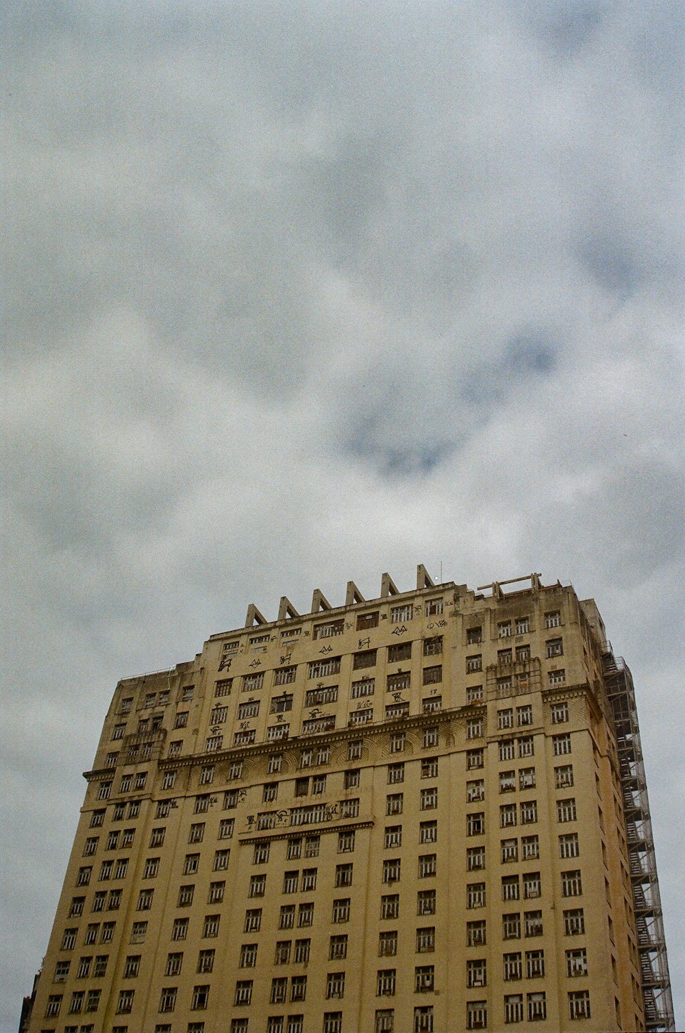 a tall building with a cloudy sky