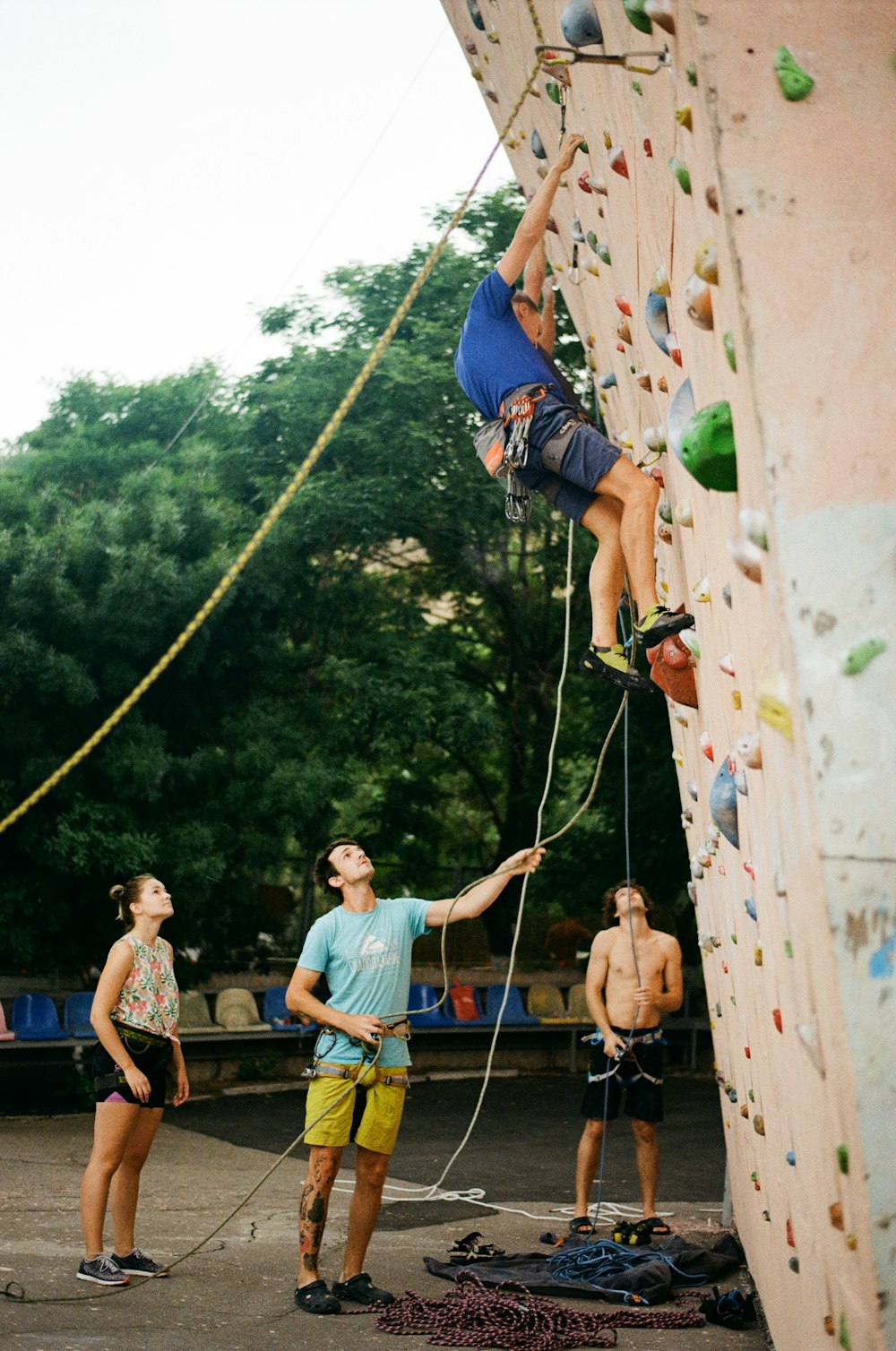 a group of people climbing a rock wall