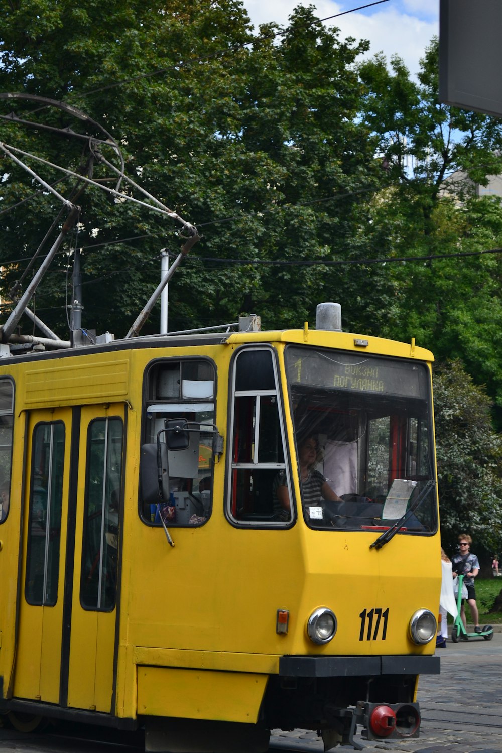 a yellow train on the tracks