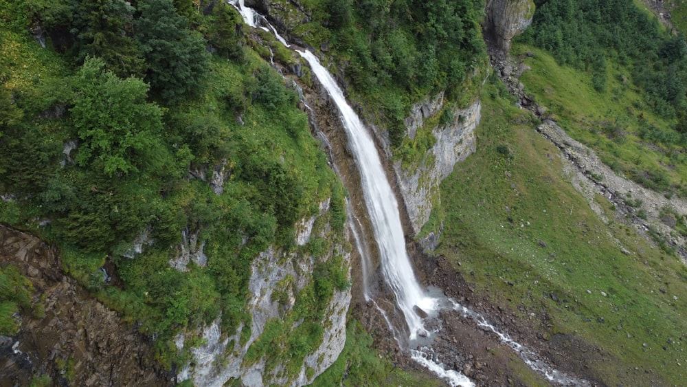 a waterfall in a green valley