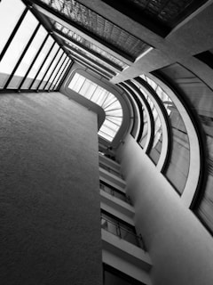 Architect reviewing building plans with client in a sunlit office