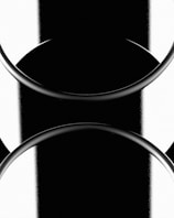 Monochrome abstract design featuring circular shapes and contrasting black and white bands, creating a balanced, symmetrical appearance with smooth curves and edges.
