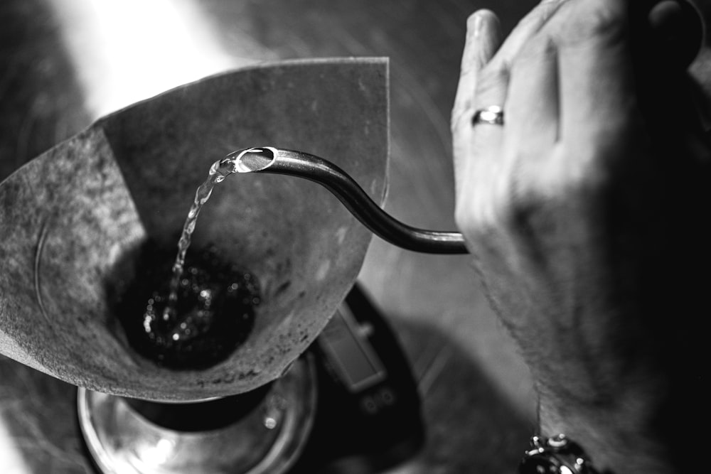 a hand holding a magnifying glass over a person's eye