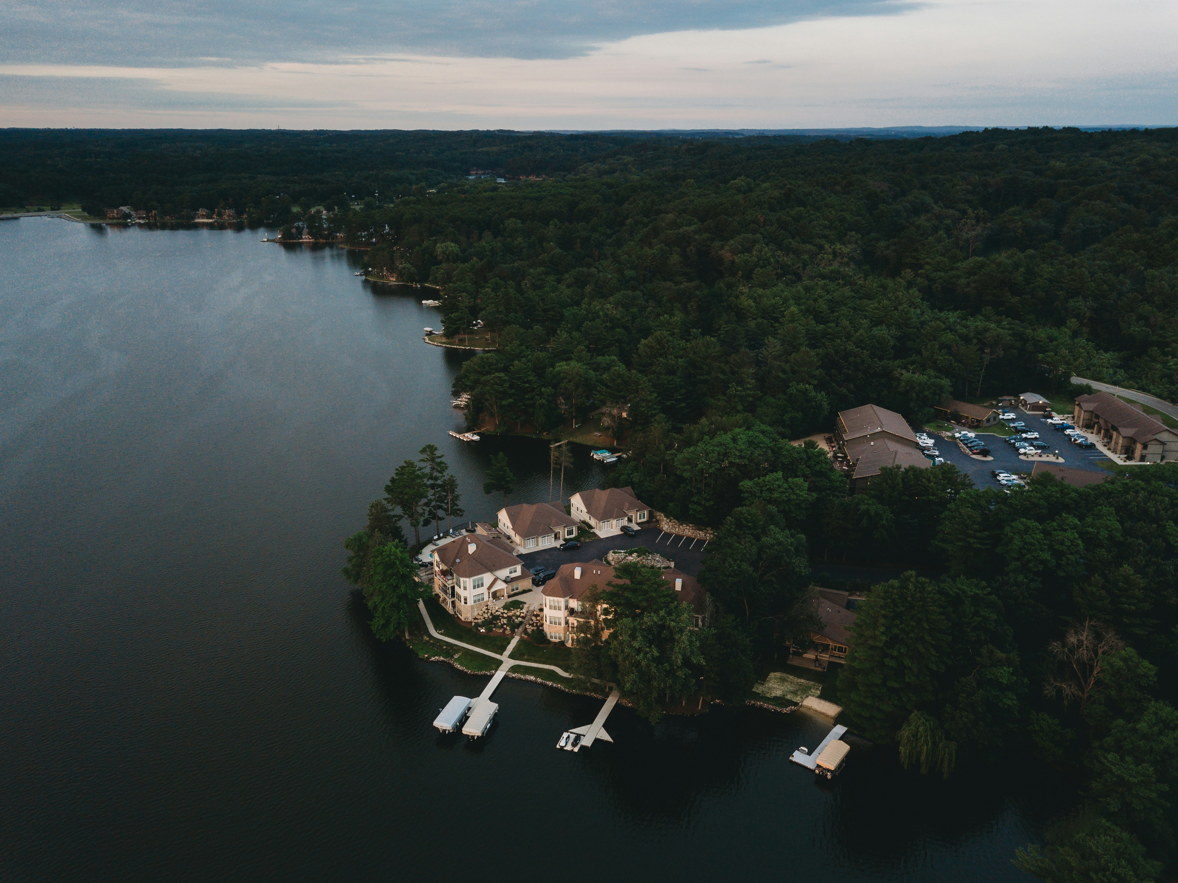 a body of water with houses and trees around it