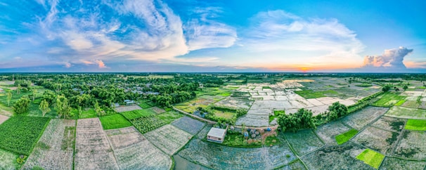 Wide panoramic view of Parras de la Fuente showcasing vineyards, desert landscape, and colonial architecture under warm sunset light.