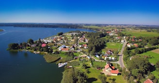 a body of water with houses and trees around it