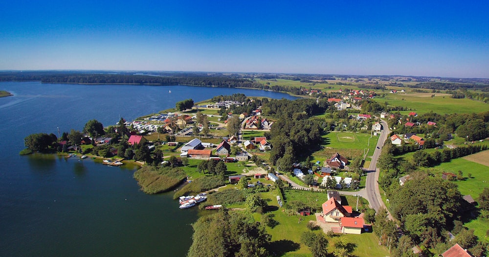 a body of water with houses and trees around it