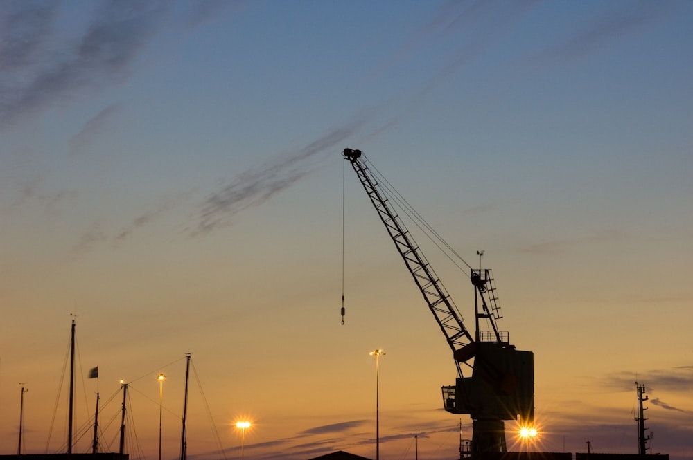a crane with a sunset in the background