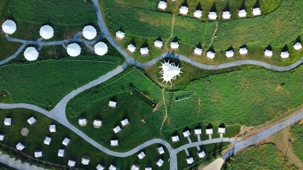 a green field with white buildings