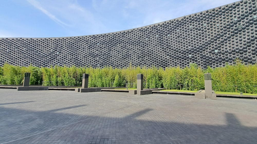 a large stone building with a large wall of plants