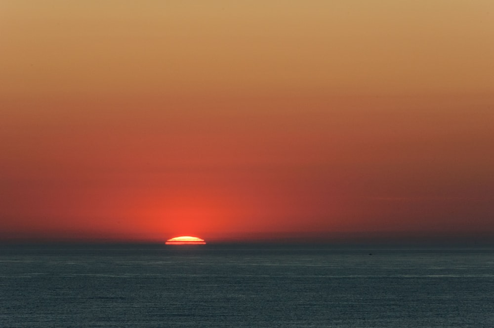 a sunset over a body of water