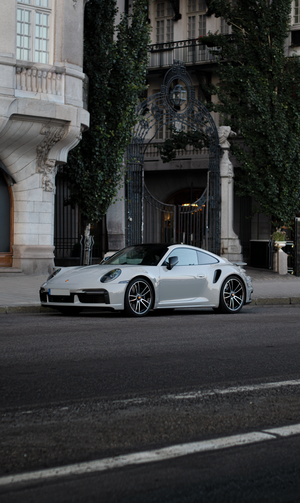 a white sports car parked on the side of a street