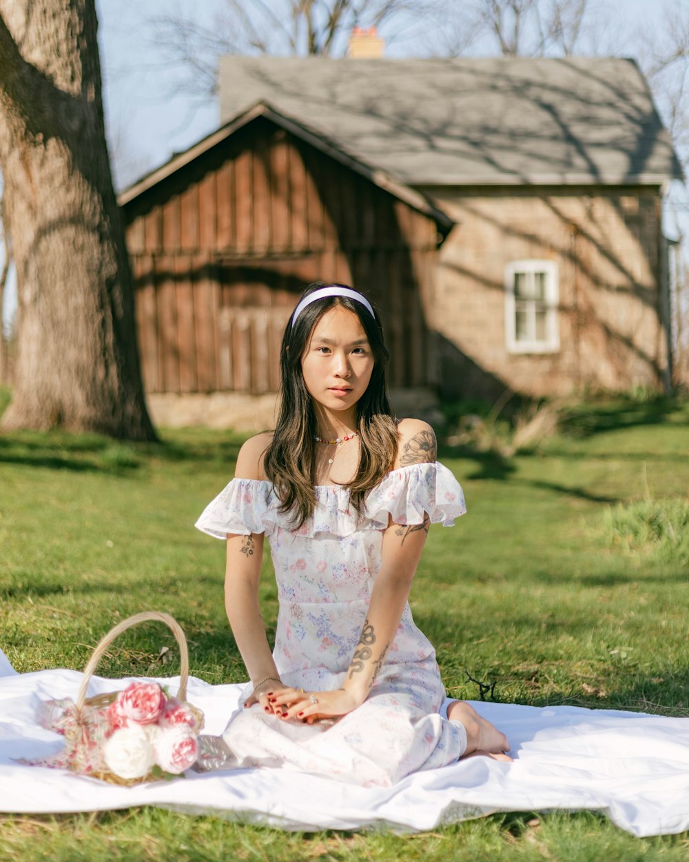 a person sitting on a blanket outside