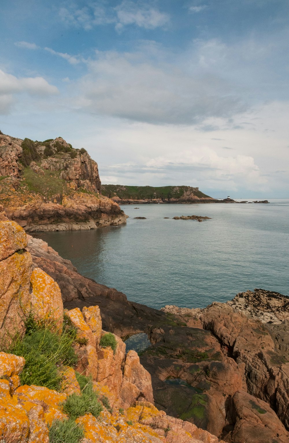 a rocky cliff overlooking a body of water