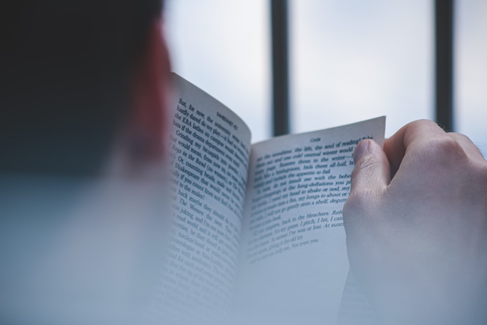 a hand holding a book