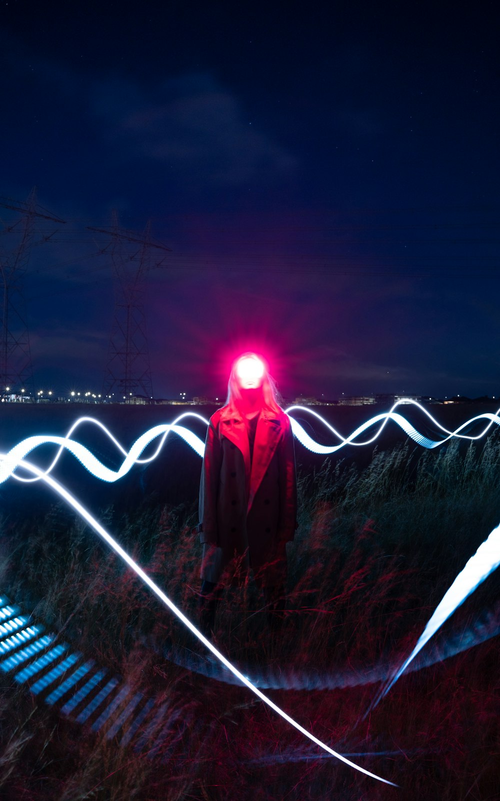 a person standing on a bridge with a bright light in the background