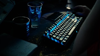 a keyboard and a glass of water