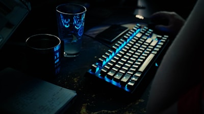 a keyboard and a glass of water