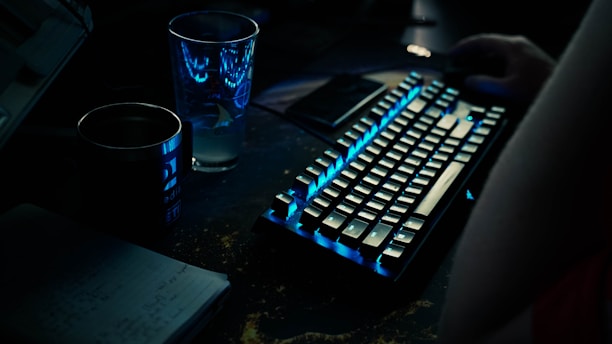 a keyboard and a glass of water