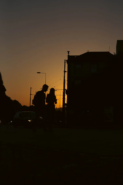 a silhouette of a couple of people