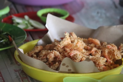 A close-up of crispy fried shrimp on a plate.