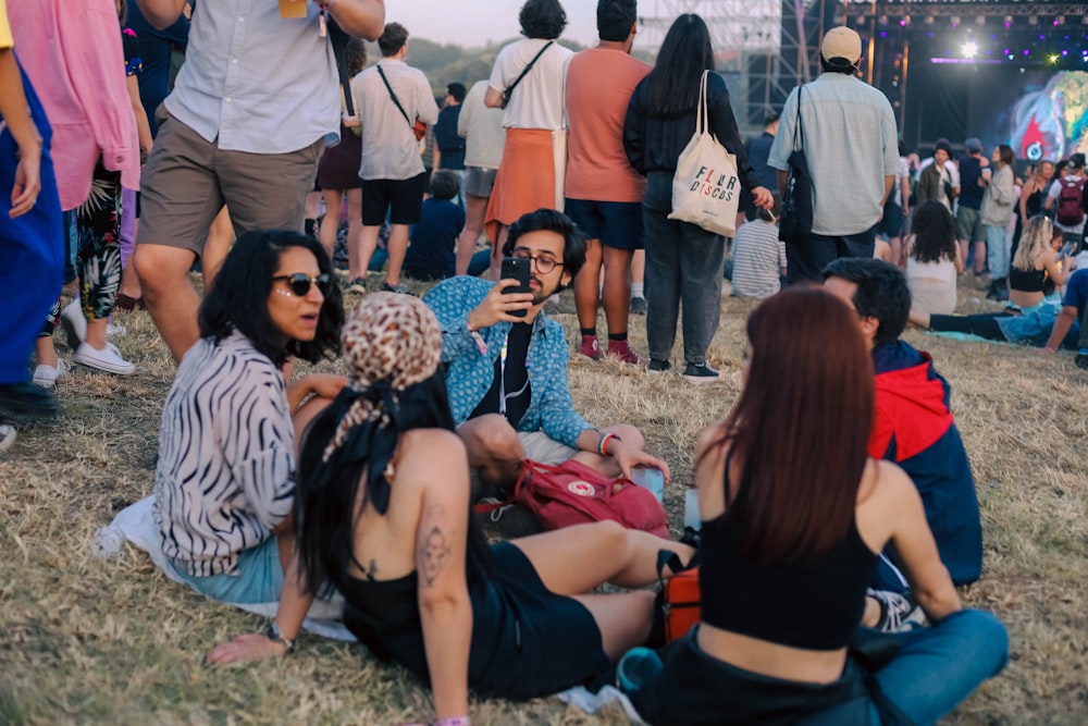 a group of people sitting on the ground