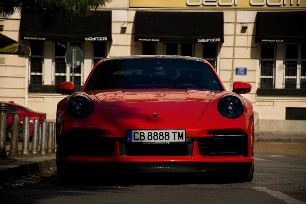 a red car parked on the side of a street