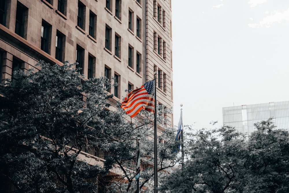 a flag on a flagpole in front of a building