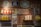 A nostalgic collection display featuring vintage-style items against a brick wall. The display includes several retro advertisements and signs in Chinese and Japanese characters, jars filled with candy, old-fashioned milk tins, a mannequin in a toy box, and a decorative straw hat.