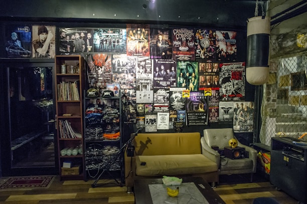 A cozy living room with a record player and posters of 80's rock bands.