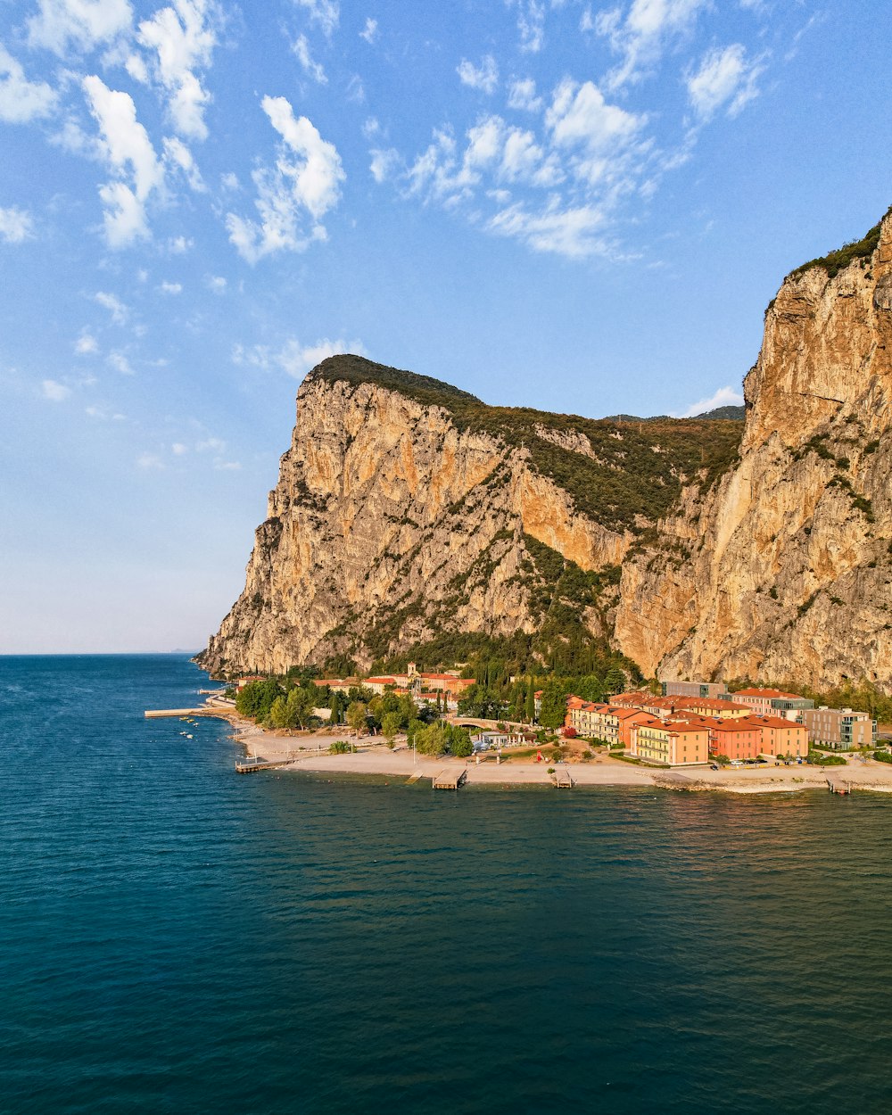 a large body of water with a mountain in the background