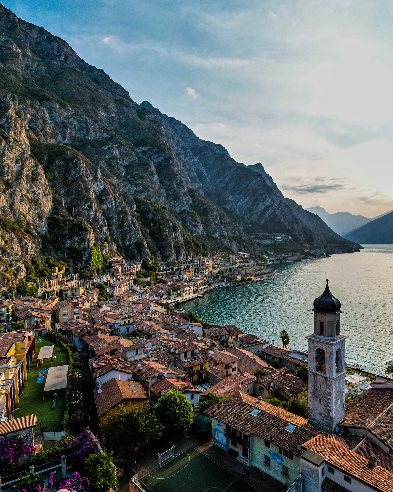 Gardasee mit Bergen und Ortschaft am Ufer