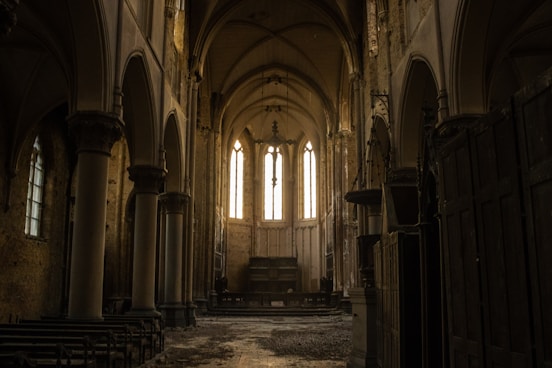 a large room with columns and windows