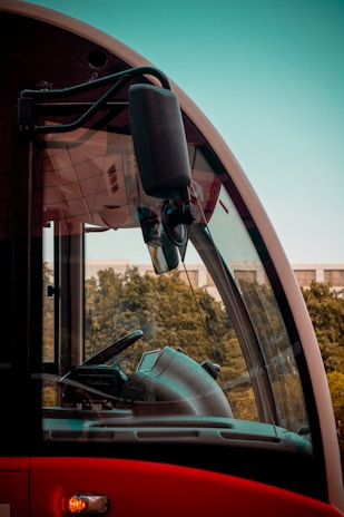 Close-up of a vehicle camera with AI capabilities mounted on a bus windshield.