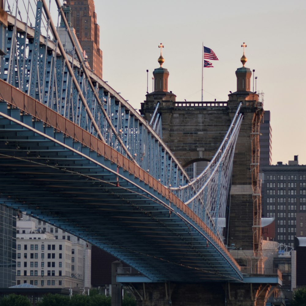 a bridge with a tower and flags