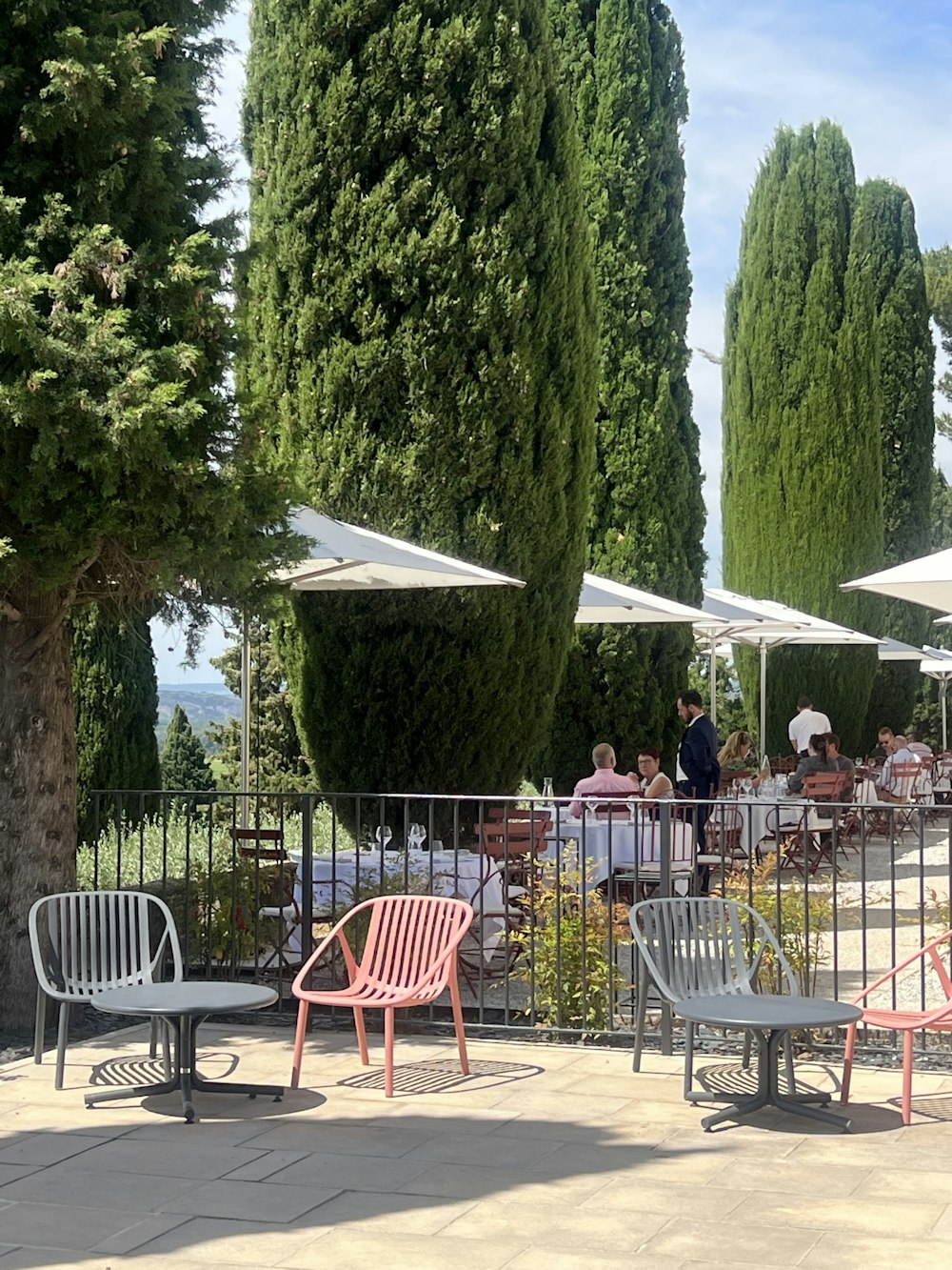 a group of people sitting at a table outside