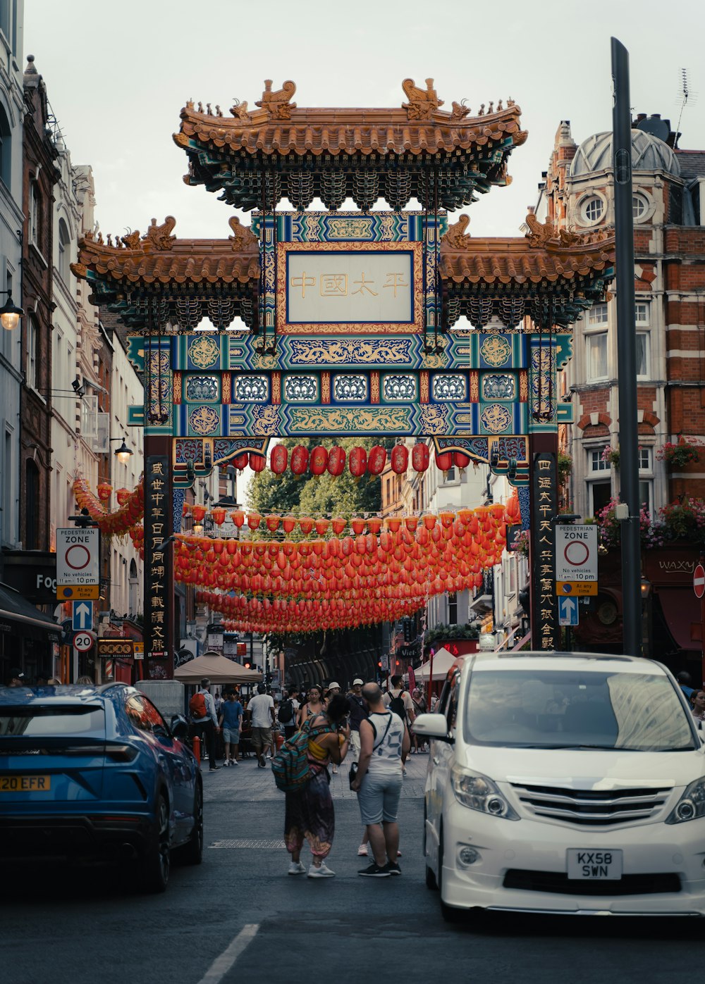 a street with cars and buildings with a sign on it