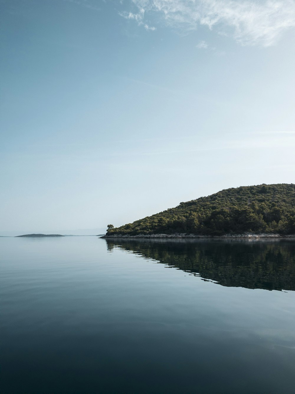 a body of water with land in the back